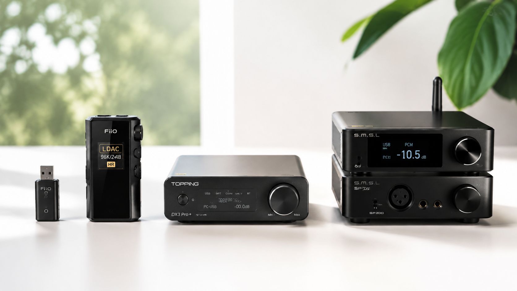 A collection of high-fidelity audio equipment including various FiiO, Topping, and S.M.S.L DACs and amplifiers on a desk.