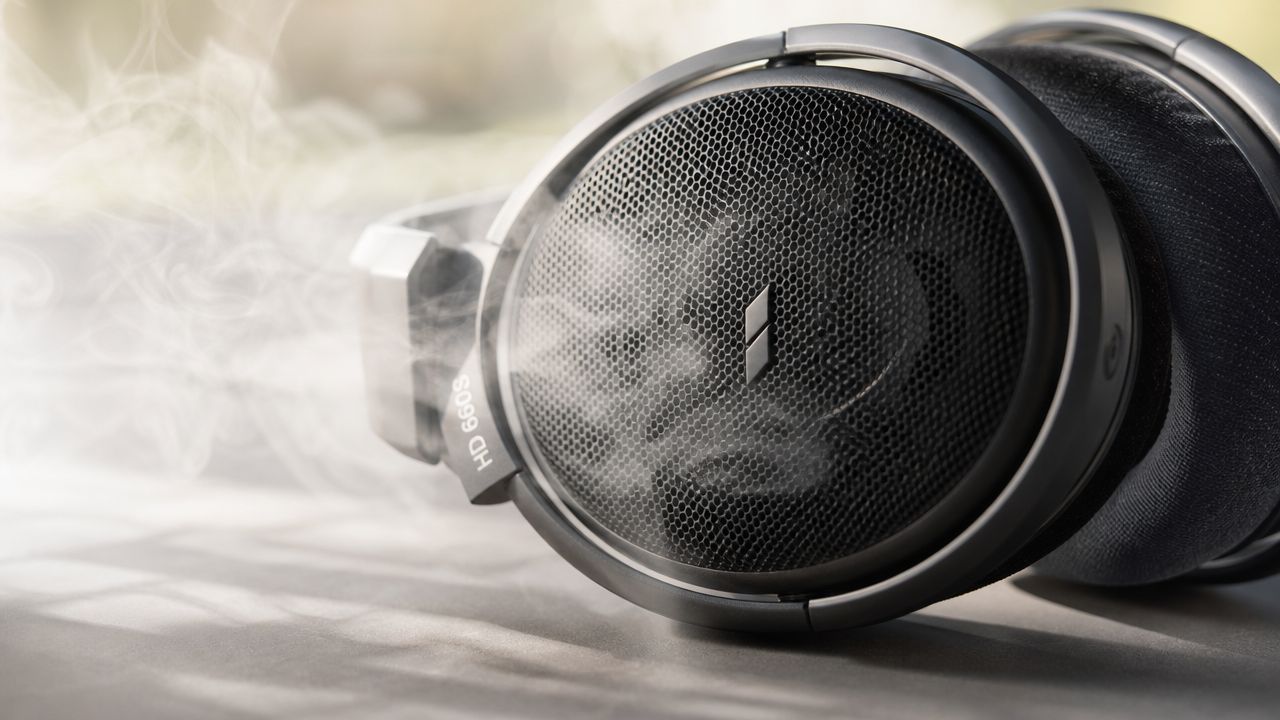 A close-up view of premium Sennheiser HD 660S open-back headphones surrounded by a wisp of light smoke.