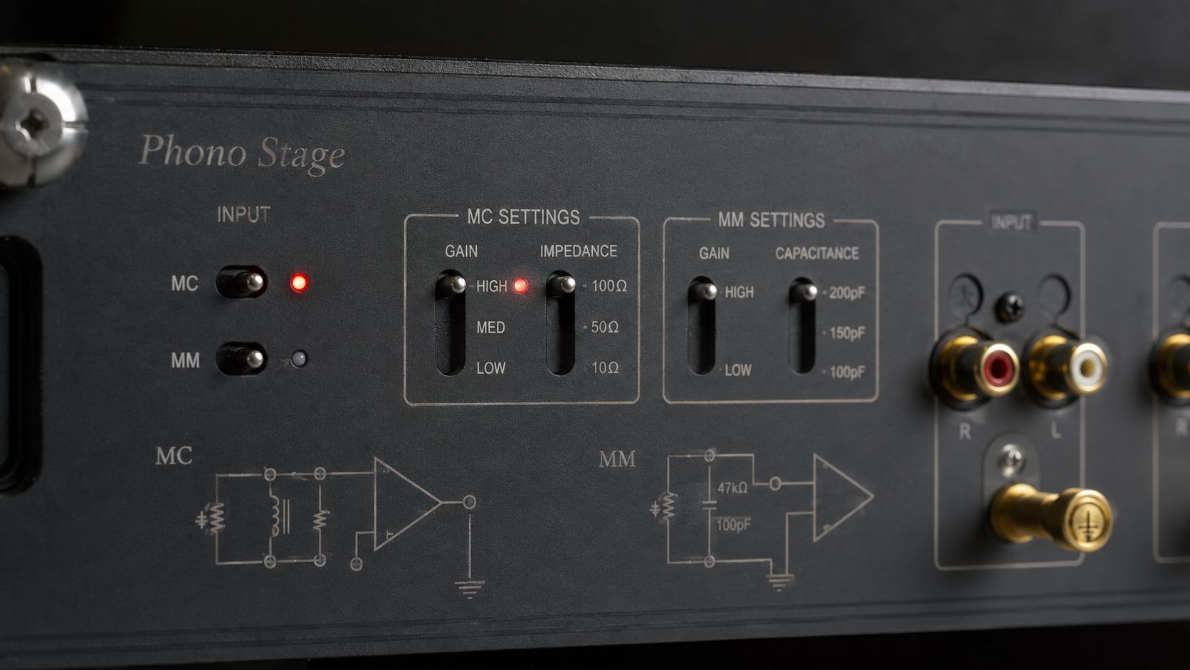A black phono stage preamplifier front panel showing selectable input settings for moving magnet and moving coil cartridges.