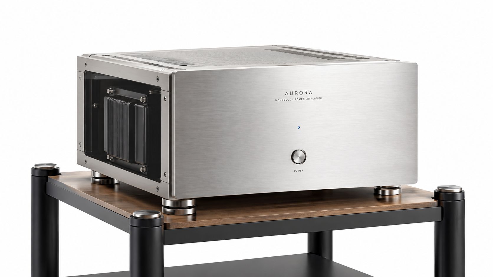 A premium Aurora monoblock power amplifier sitting on a modern wooden audio equipment rack shelf.