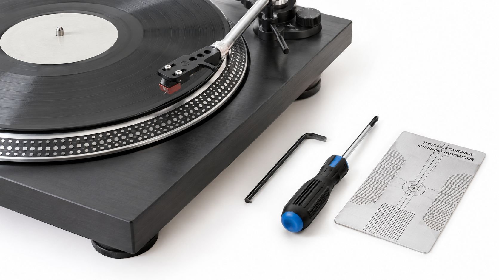 A black vinyl record player with a cartridge alignment protractor tool and screwdriver on a white background.